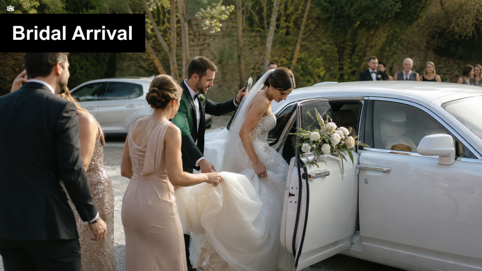 A bride in a white wedding gown exits a luxury car with assistance at a formal event.